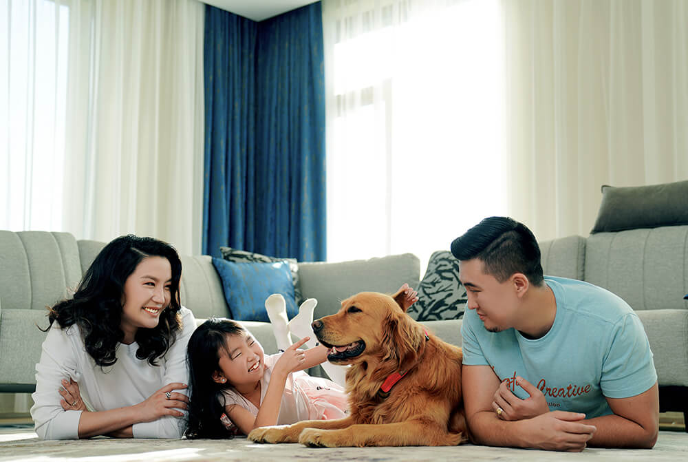 Family laying with their dog in the living room