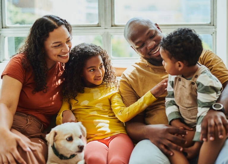 Family laying with their dog in the living room
